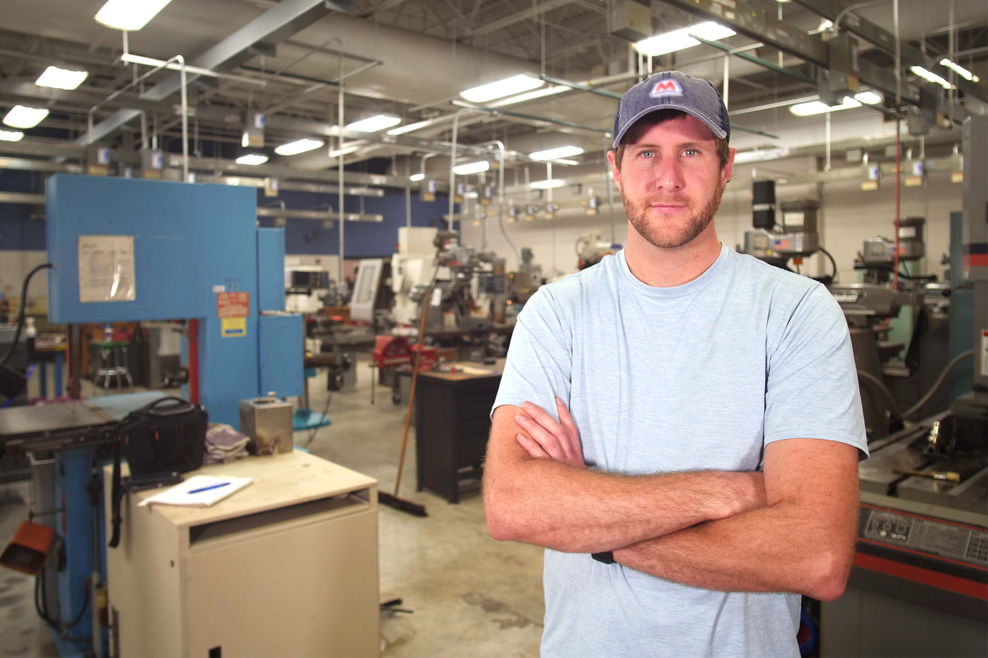 Jesse standing in front of machinary